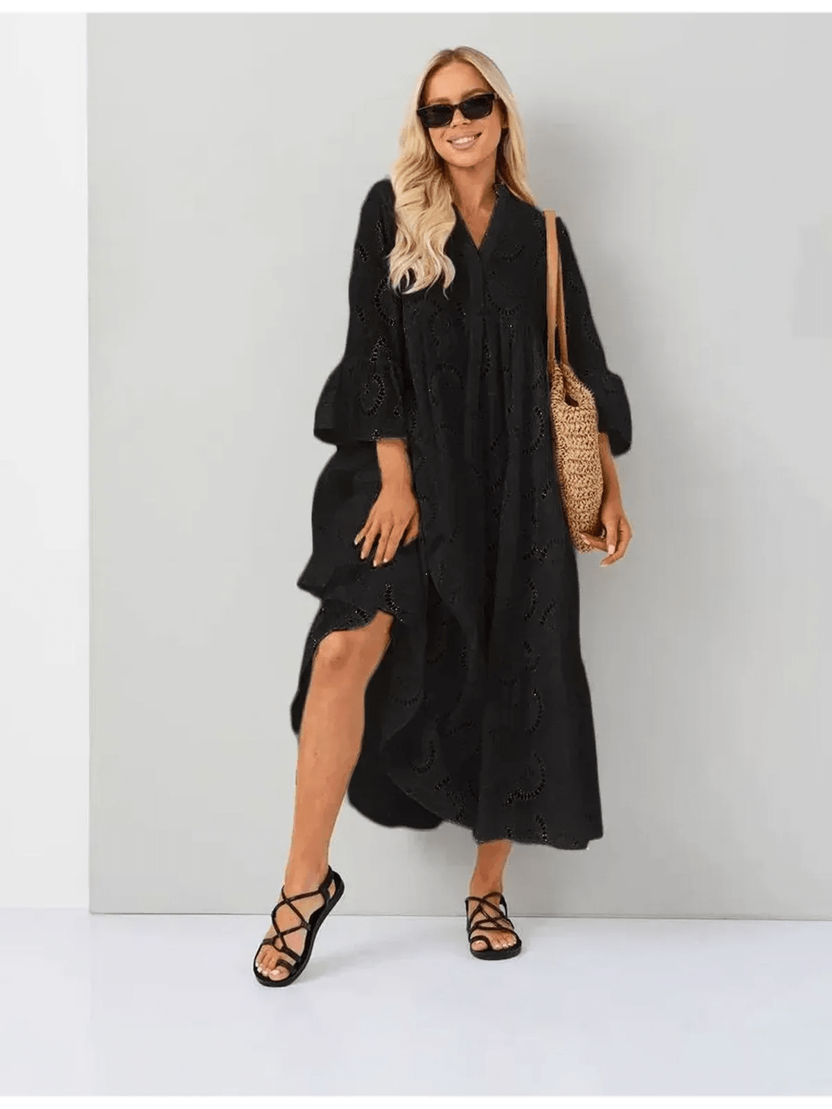 Woman wearing a Midnight Broderie Maxi Dress with a flowy silhouette and broderie anglaise detailing. Perfect for any occasion.