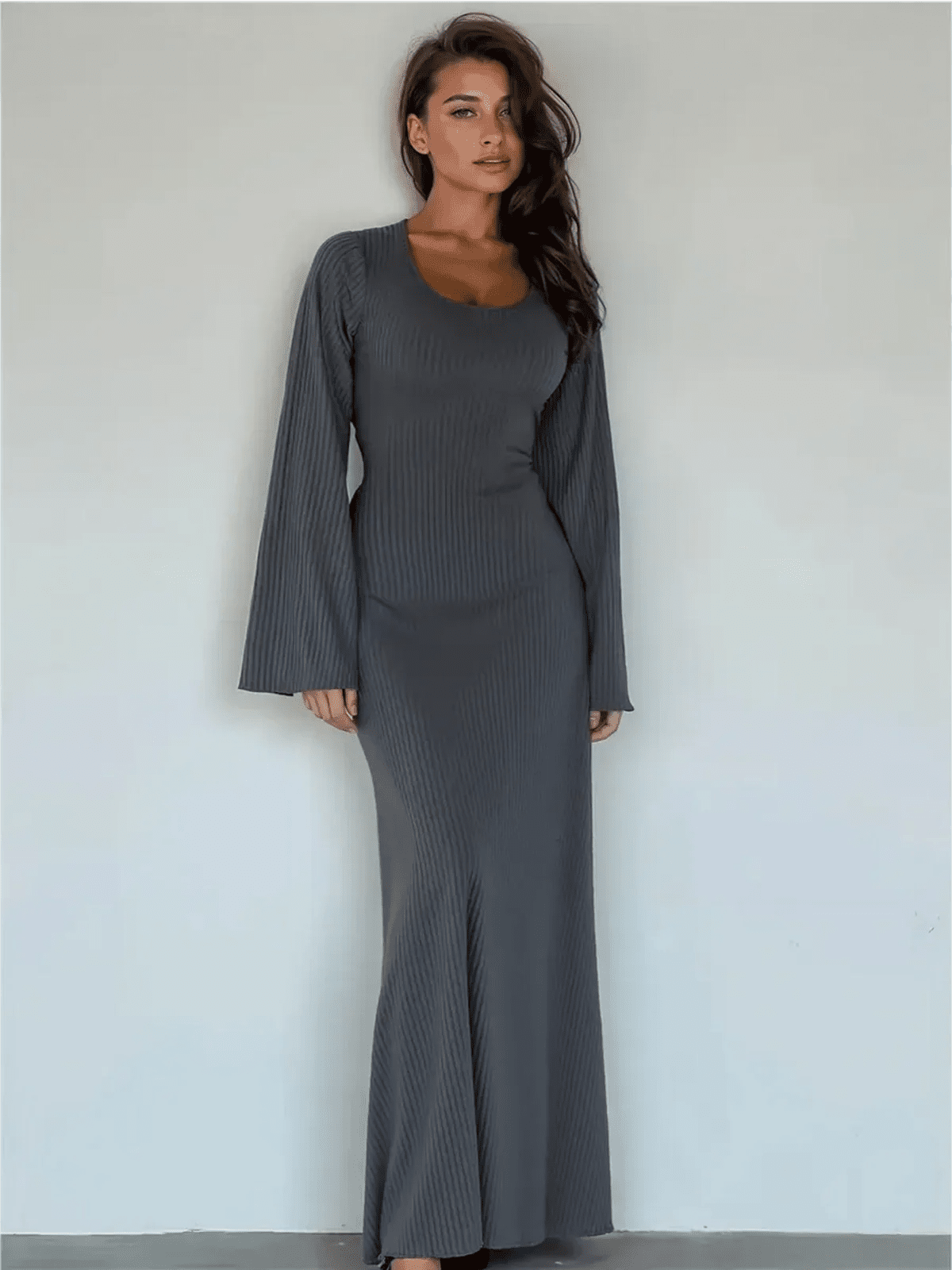 Stunning model wearing the Granite Luxe Maxi Dress with flared sleeves and ribbed texture in elegant gray.