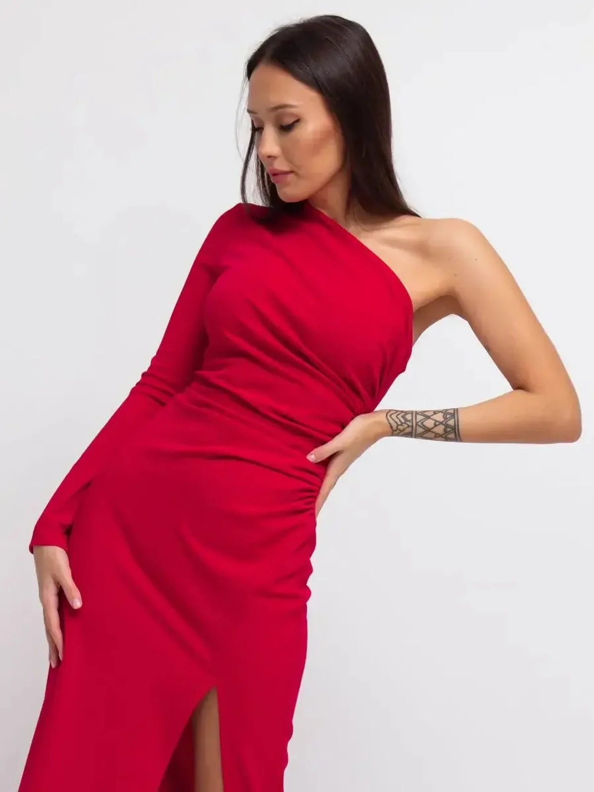 One-shoulder deep red maxi dress with thigh-high slit, showcasing modern elegance and sophisticated style.