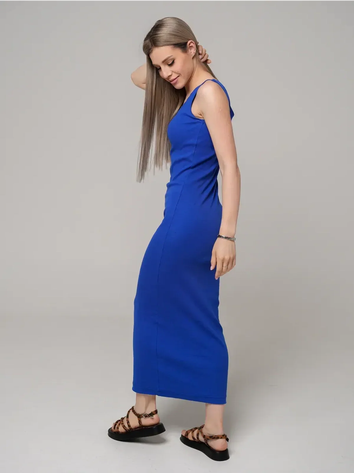 Azure Elegance Maxi Dress in cobalt blue on a model, showcasing its sleek ribbed silhouette and ankle-skimming length.
