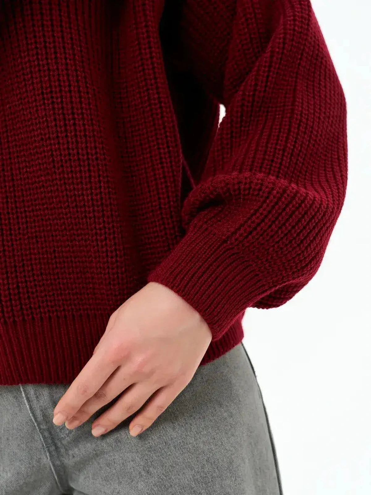Detail of the Crimson Charm Sweater by Lauven, showcasing the oversized knit and deep burgundy color.