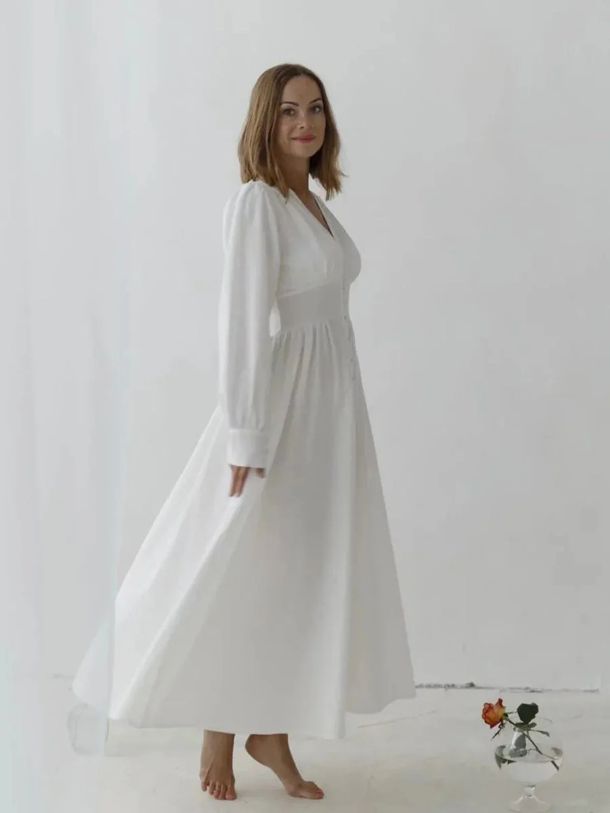 Model in a white Heirloom Maxi Dress, showcasing vintage-inspired elegance and modern comfort in a flowing silhouette.