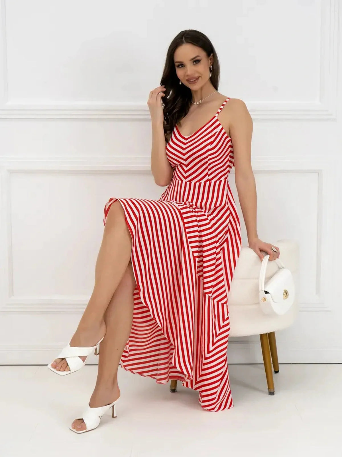 Model wearing a red-and-white striped maxi dress with a chevron design, showcasing its breezy and elegant style.