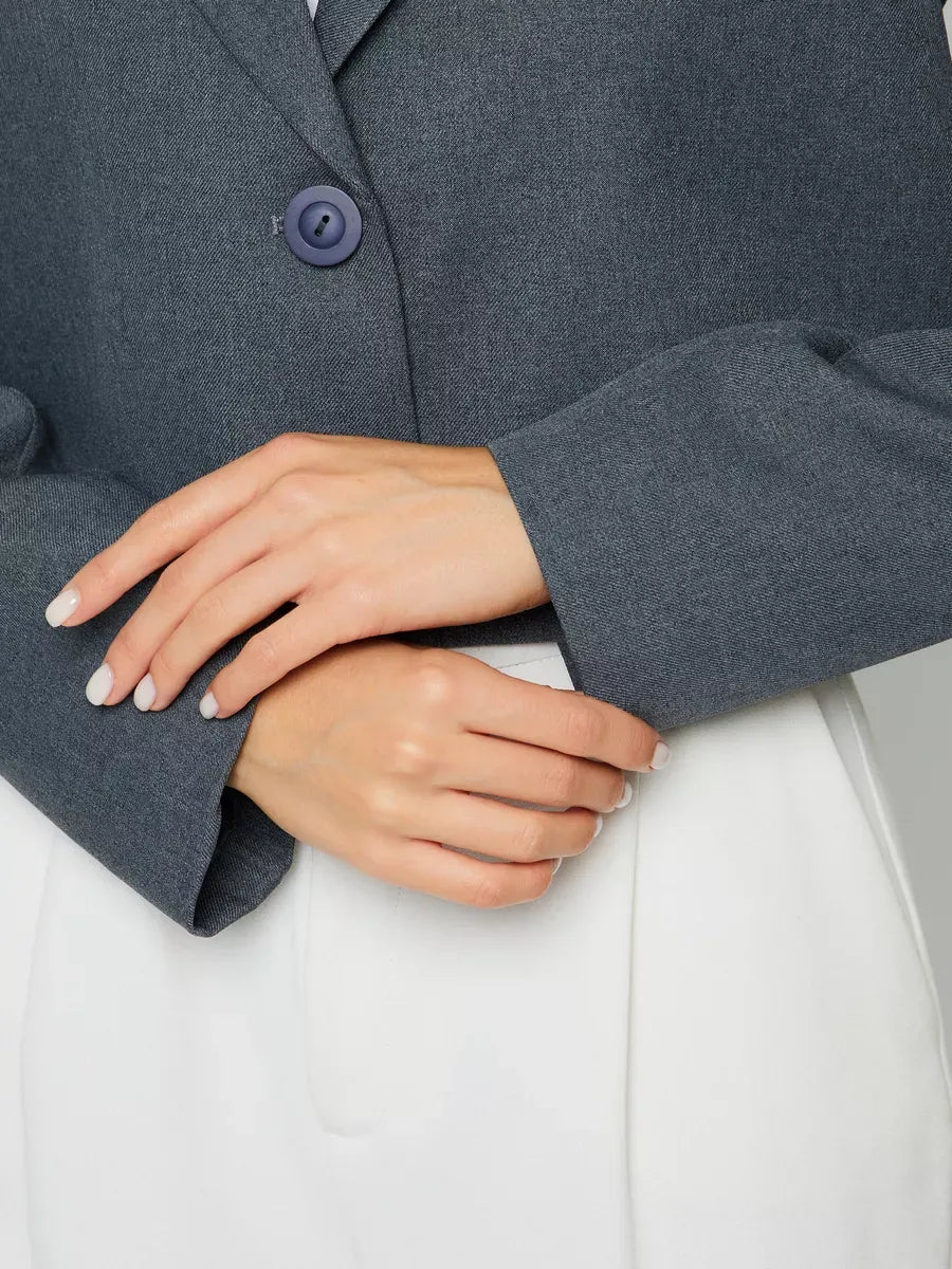 Athena Blazer by Lauven showcasing women's grey cropped oversized jacket detail with stylish button and elegant sleeves.