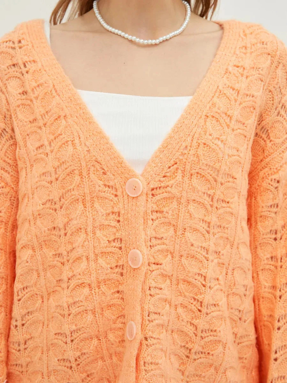 Elysia Cardigan by Lauven in soft jacquard knit, vibrant coral hue, V-neckline, perfect for comfort and style.