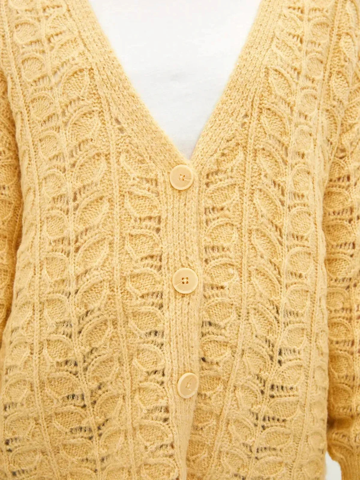 Solenne Cardigan by Lauven in warm yellow with textured jacquard pattern and V-neckline for relaxed elegance.