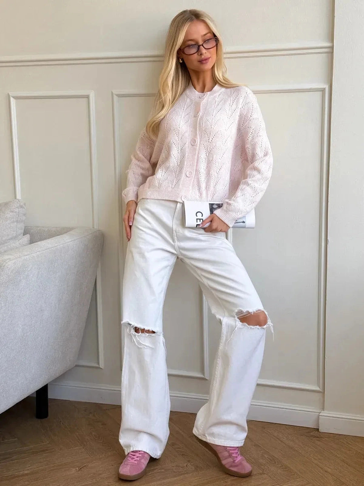 Lauven Blush Cardigan in soft pink knit paired with white ripped jeans, showcasing elegant openwork lace pattern.