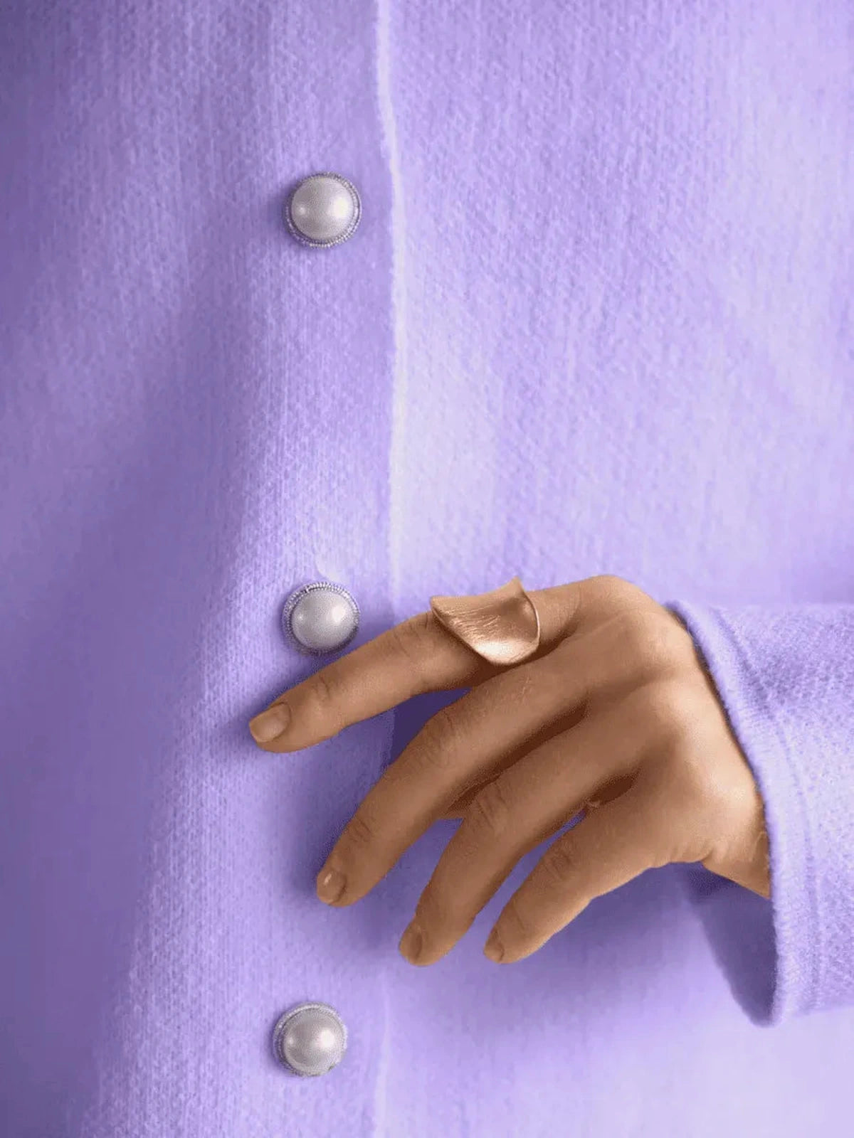 Lilac Cardigan by Lauven, featuring warm purple knitwear with button closure and a stylish hand adorned with a ring.