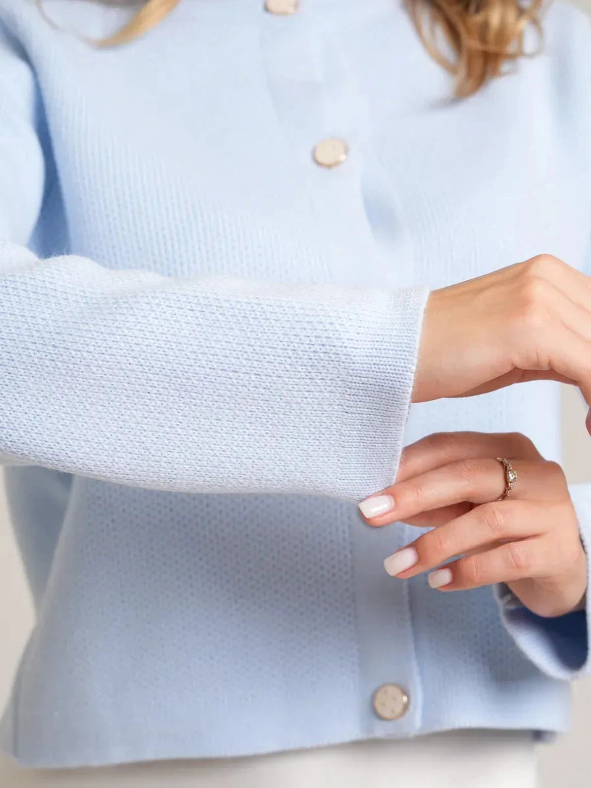 Celeste Cardigan by Lauven in light blue, featuring decorative buttons and a soft knit texture for elegance.