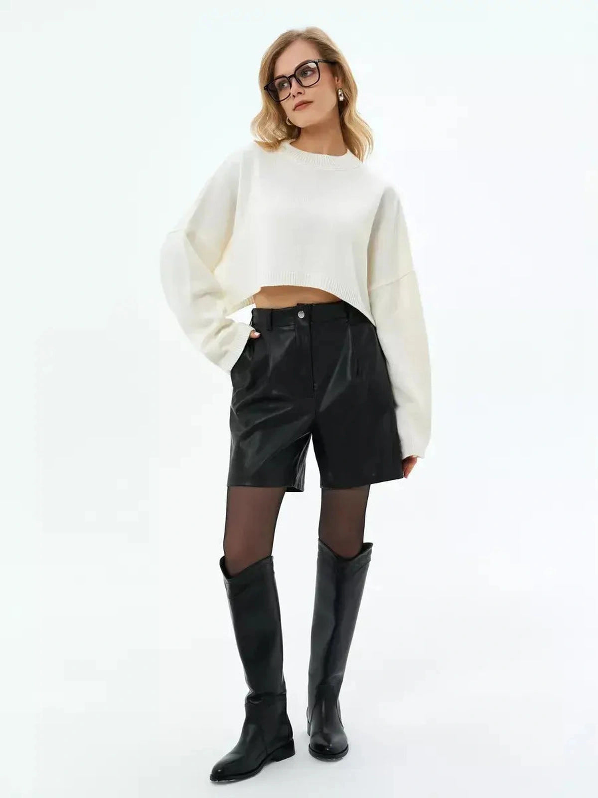 Ivory Sweater by Lauven styled with black leather shorts and knee-high boots, highlighting a modern cropped look.