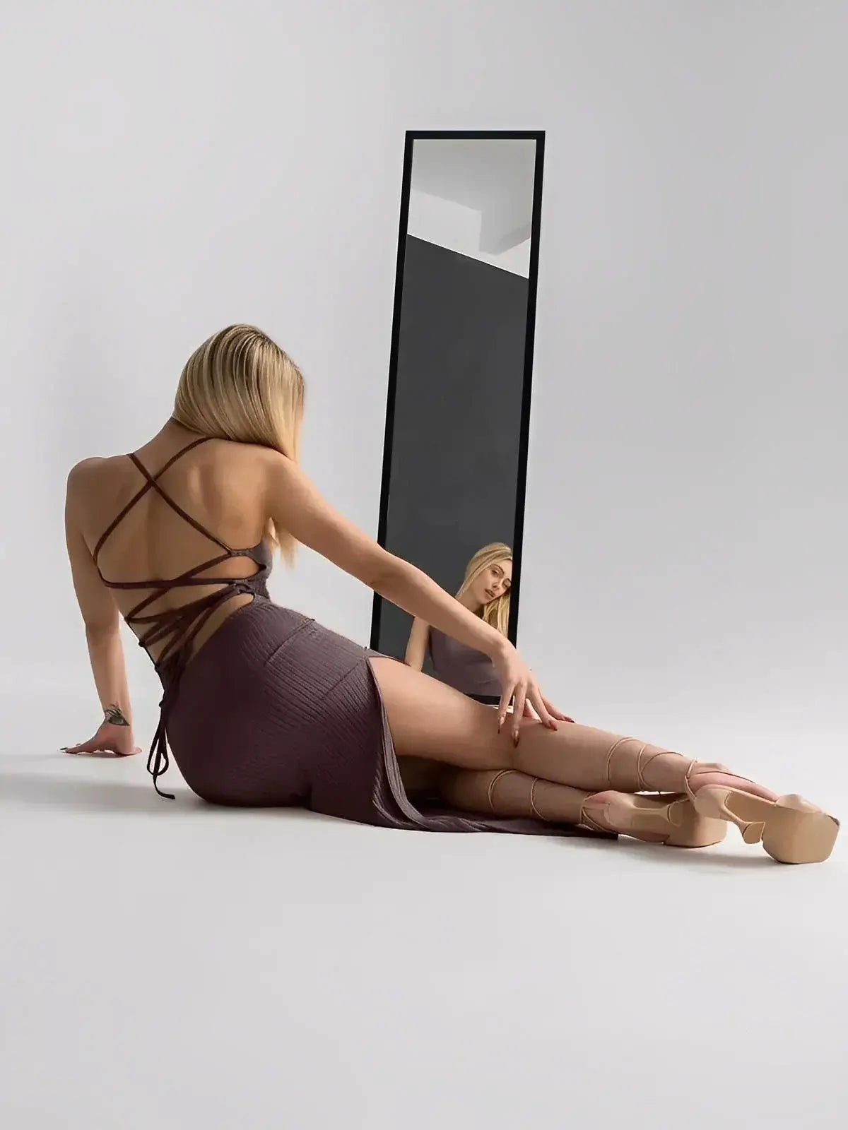 Model showcasing the Lauven Obsidian Midi Dress with strappy back and thigh-high slit.