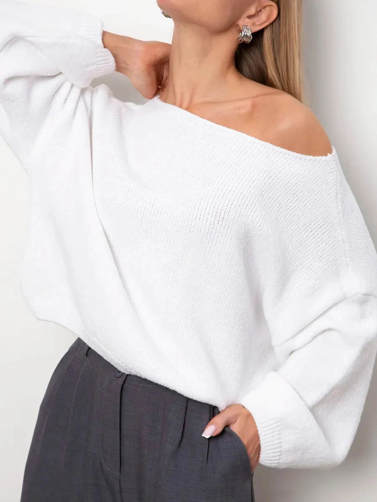 Stylish woman wearing Snowfall Sweater by Lauven, an oversized white knit sweater with a boat neck.