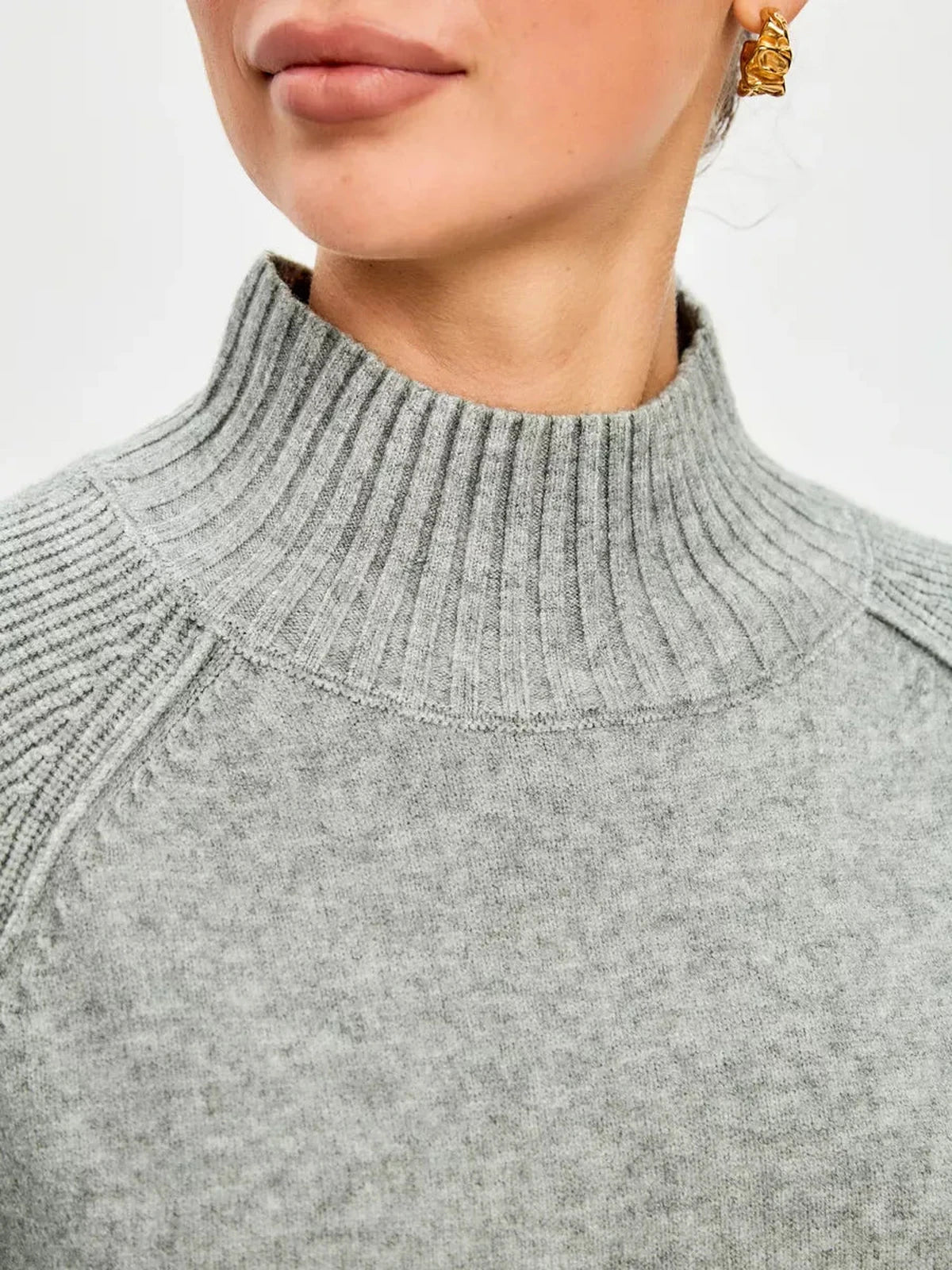 Close-up of the Sterling Sweater by Lauven, featuring a high ribbed neckline in soft grey cashmere blend.
