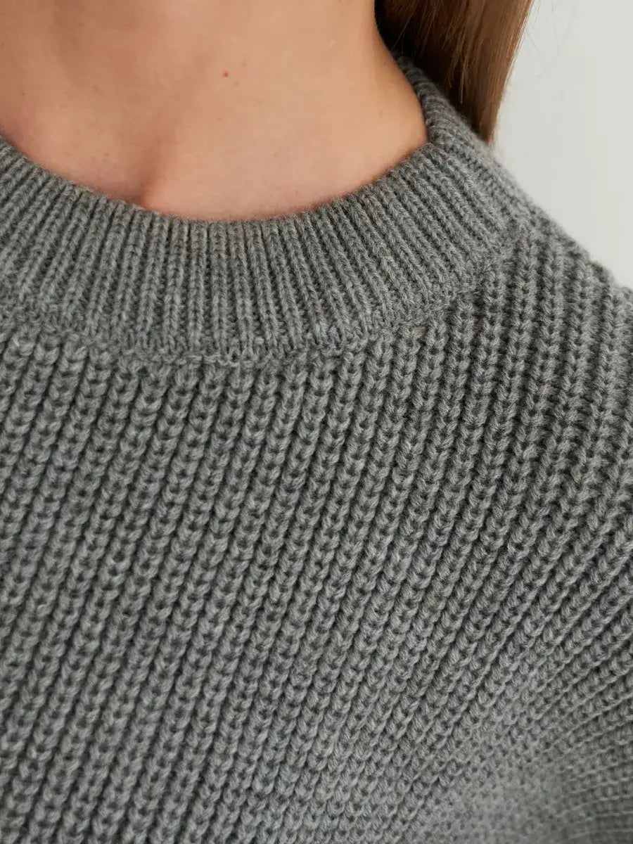 Close-up of the neckline of the Lauven Vega Sweater in grey rib-knit, showcasing its cozy elegance.