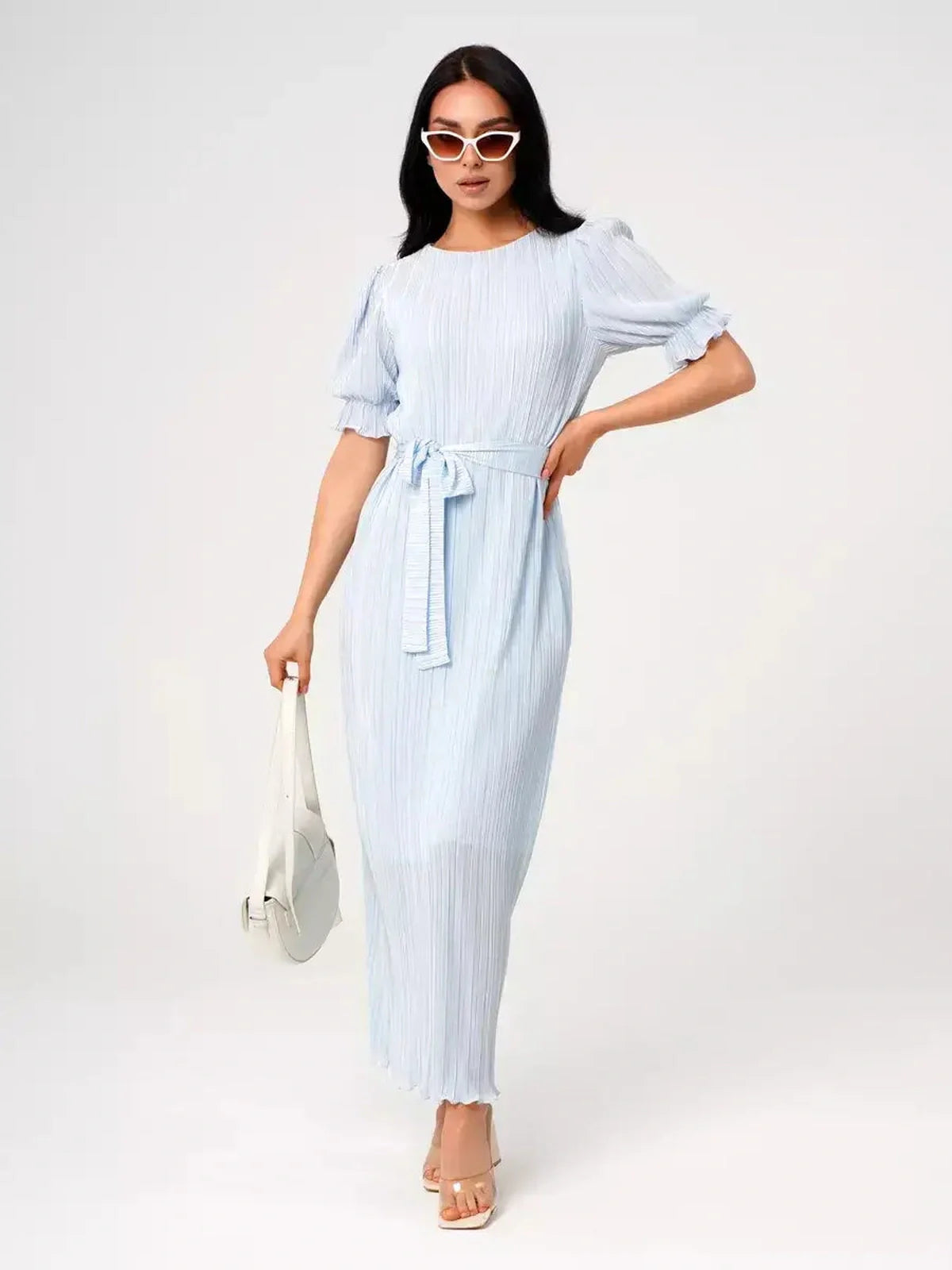 Celeste Flow Maxi Dress in light blue with pleats and waist tie, perfect summer dress for weddings and formal occasions.
