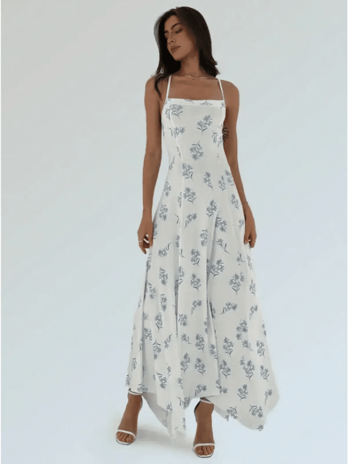 Maxi Dress Bluebelle featuring blue floral print, handkerchief hem, and strappy open-back, perfect for summer events.