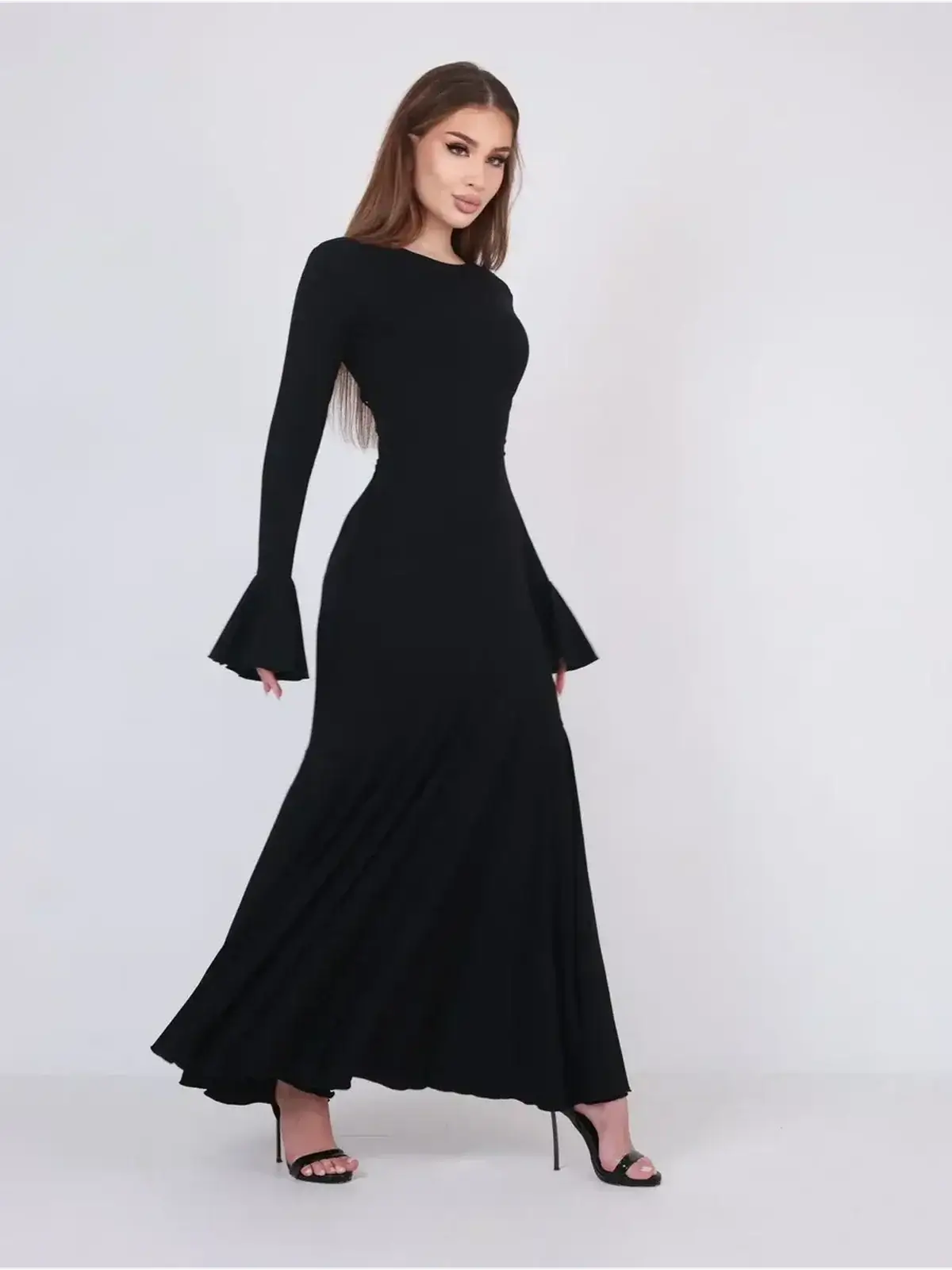 Elegant black Mirage Maxi Dress featuring flared cuffs and fishtail hem, ideal for formal events.