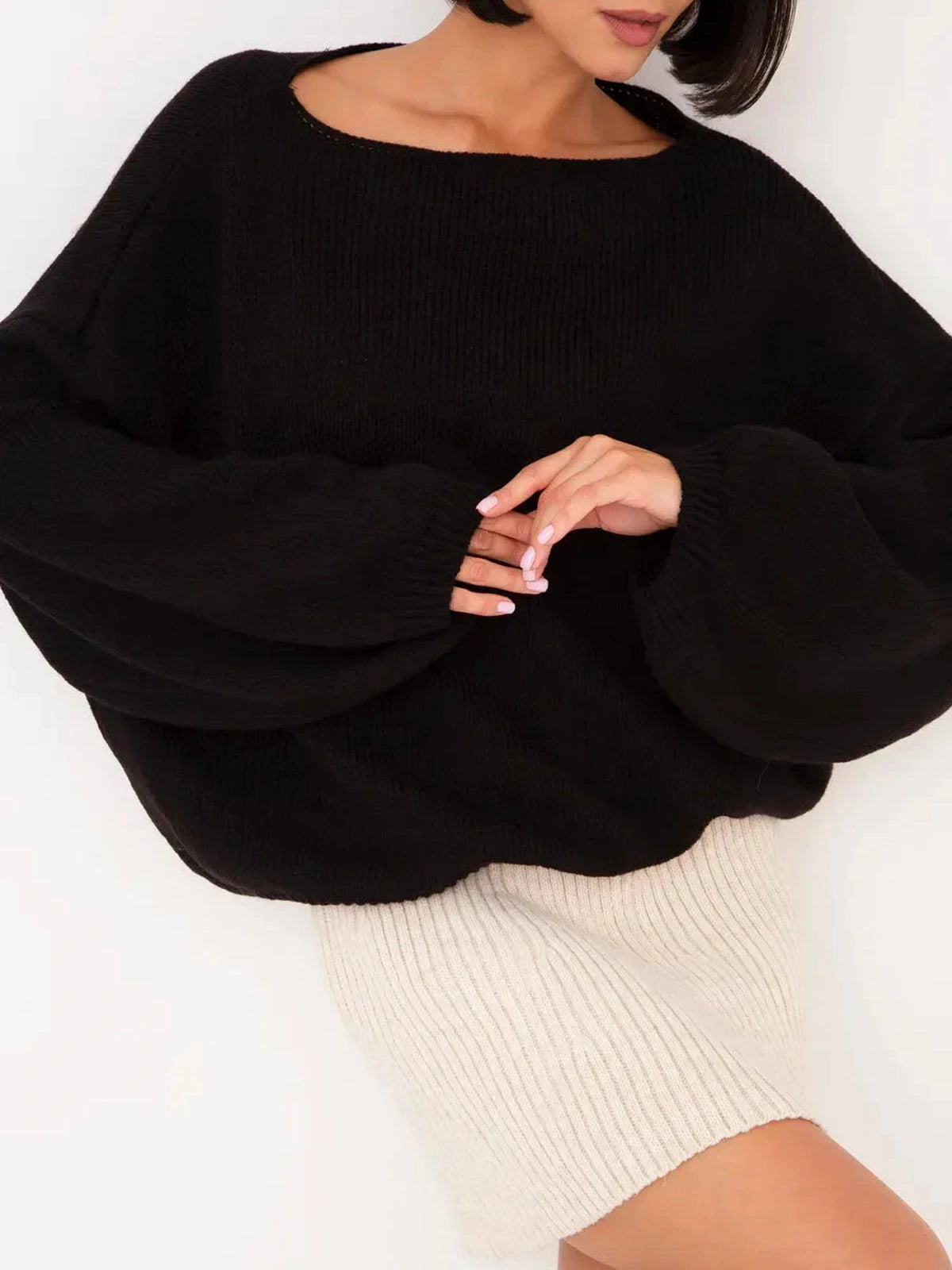 Onyx Sweater by Lauven - Oversized women's knit sweater with boat neck in black, paired with a cream skirt.