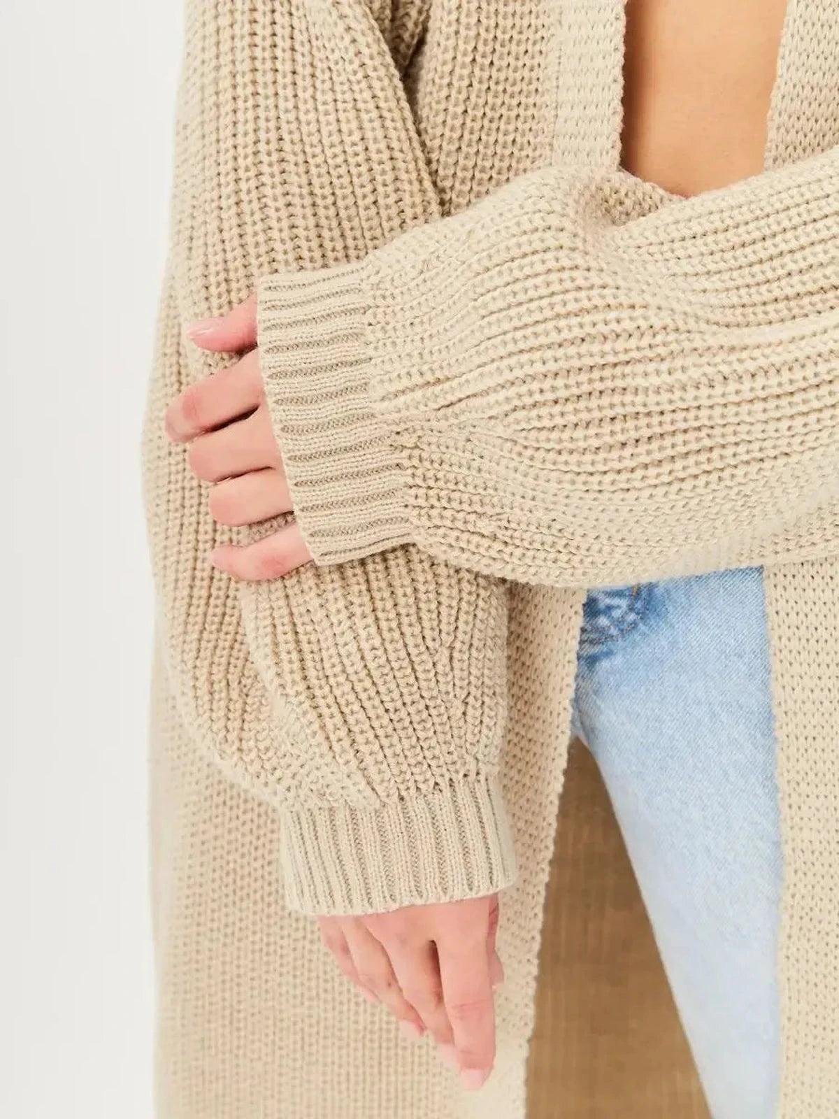 Close-up of sleeves of Sable Cardigan by Lauven, showcasing soft knit texture and oversized fit.