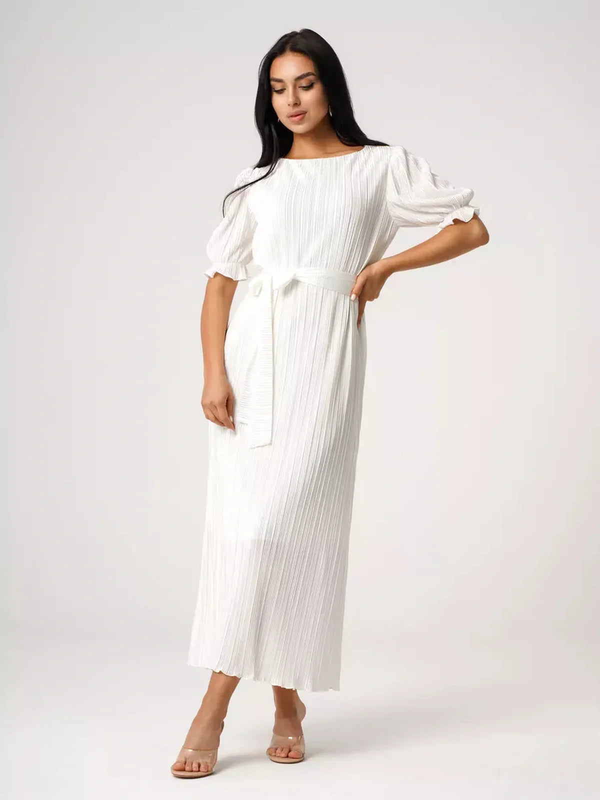 Model showcasing the Seraphine Maxi Dress, a lightweight pleated white dress, perfect for summer elegance.