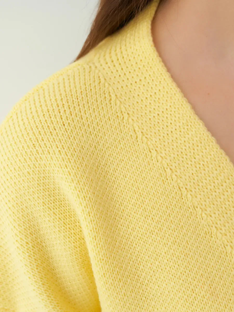 Close-up of the Solara Cardigan by Lauven, featuring a soft yellow knit texture and stylish collar design.