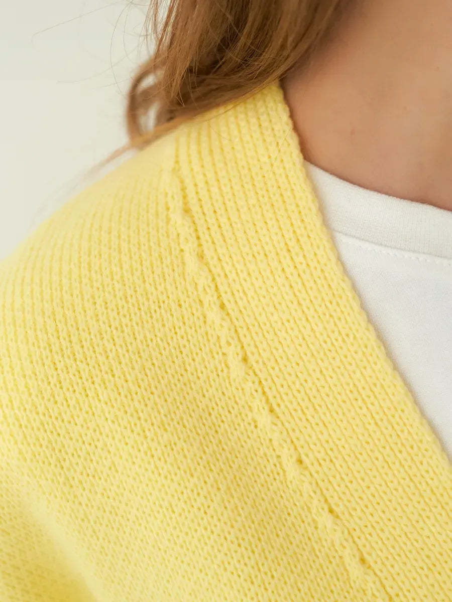 Sunny Cardigan by Lauven – Close-up of soft yellow knitwear texture and detail.
