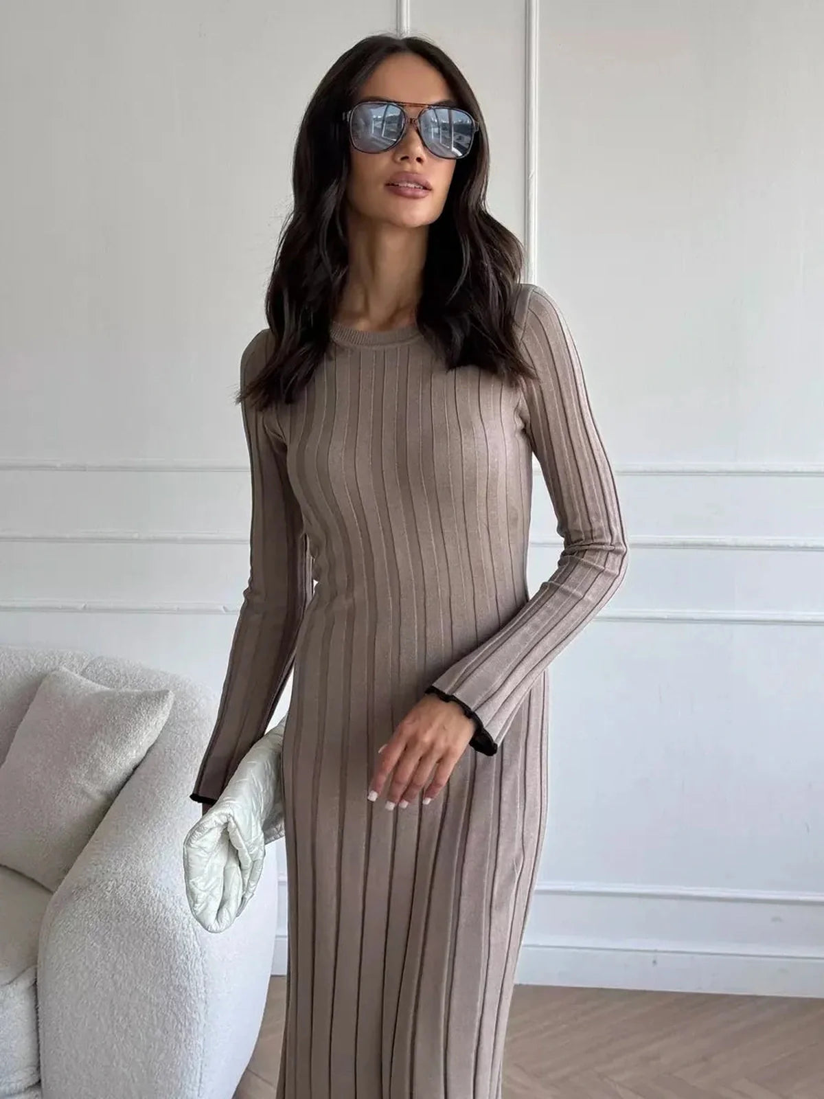 Stylish woman in a ribbed knit Contour Maxi Dress, showcasing full-length elegance and modern sunglasses.