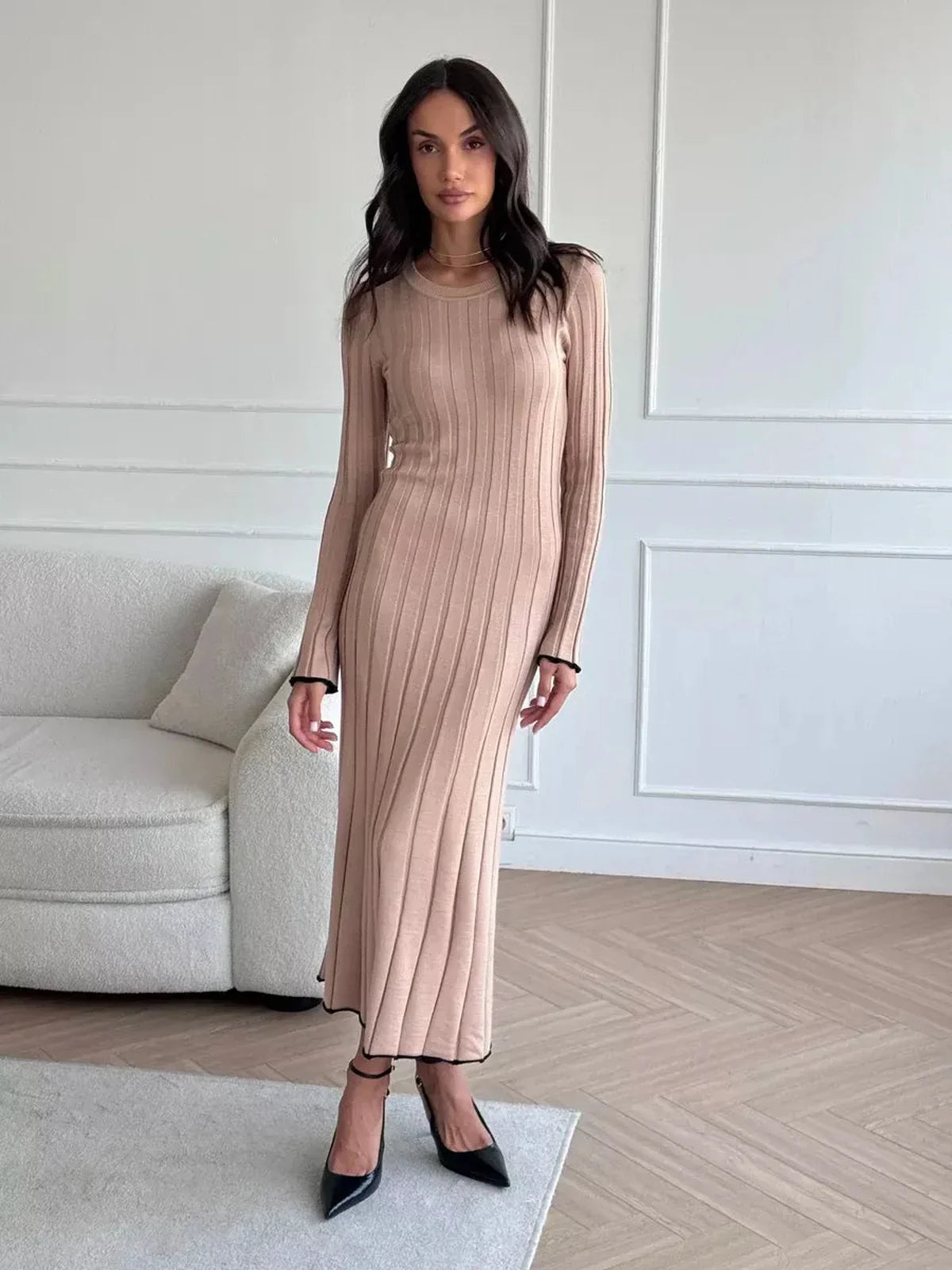 Model wearing Sahara Curve Maxi Dress in sandstone beige, showcasing soft ribbed texture and elegant full-length cut.