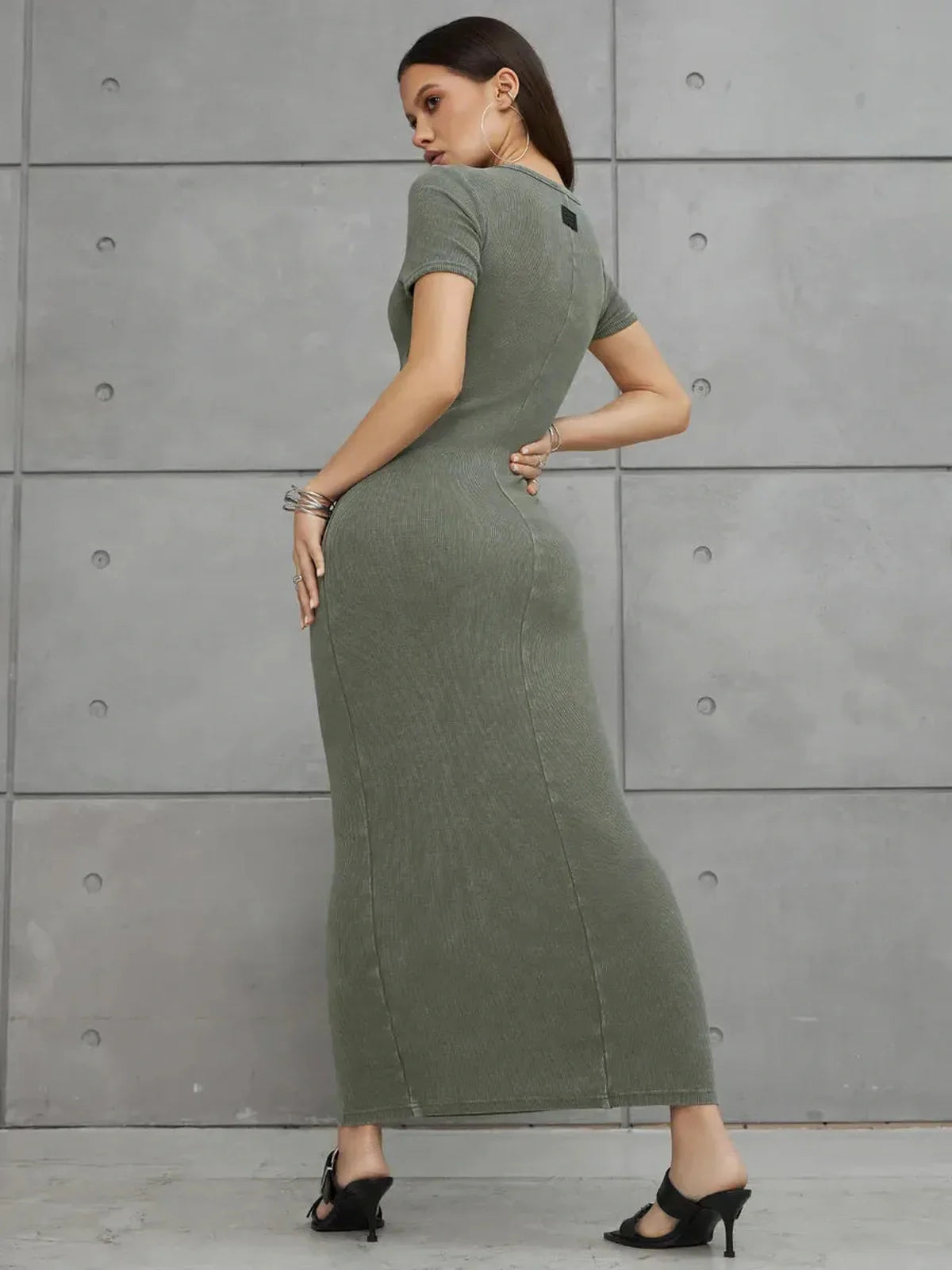 Olive Line Maxi Dress in khaki green ribbed cotton, showcasing a fitted silhouette and precise seam detailing.