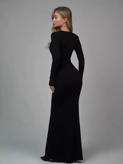 Back view of a woman in a black Sculpted Elegance Maxi Dress, showcasing a sleek and seamless silhouette.