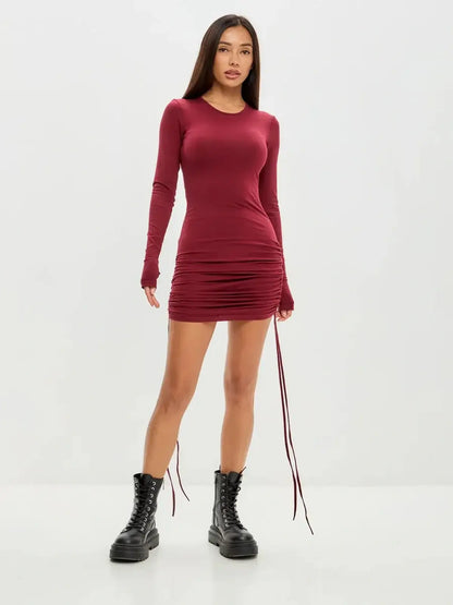 Women’s burgundy long sleeve mini dress with side draping, perfect for party or cocktail events.