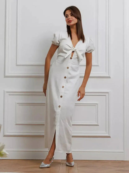 Maxi Dress Pearl Whisper in white with tie-front bodice, puff sleeves, and button-down skirt in stylish interior setting.