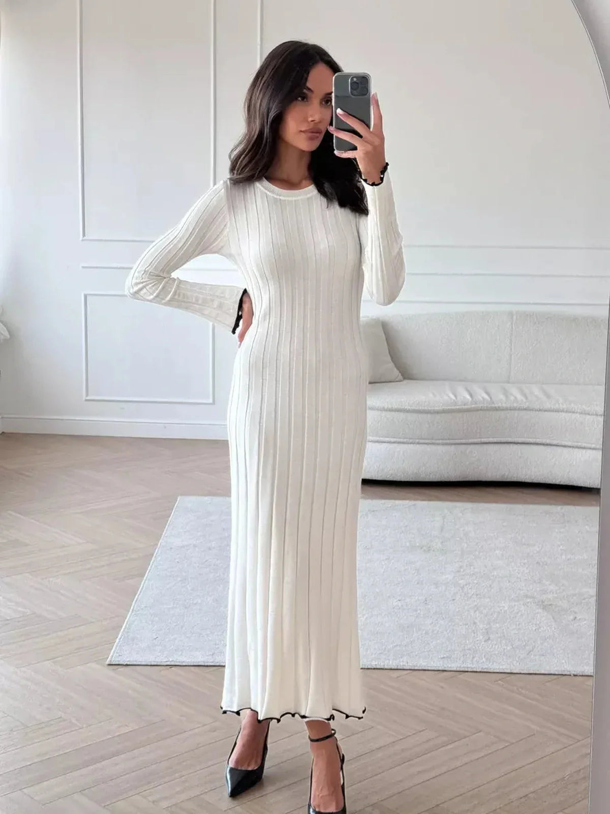 Ivory Grace Maxi Dress featuring a ribbed knit texture, long sleeves, and a delicate ruffle trim for elegant movement.