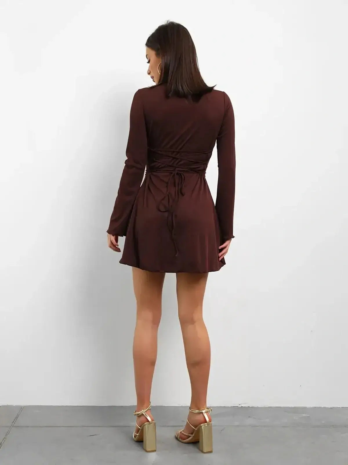 Back view of Cocoa Laced mini dress, featuring a lace-up detail and long sleeves in rich chocolate tone.