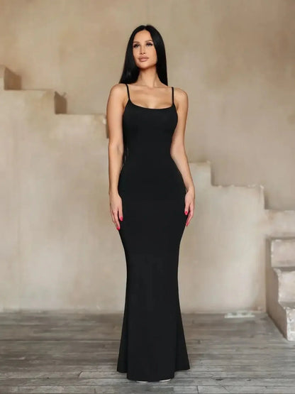 Model wearing the Sculpted Grace Maxi Dress, showcasing its sleek and elegant design in a stylish indoor setting.
