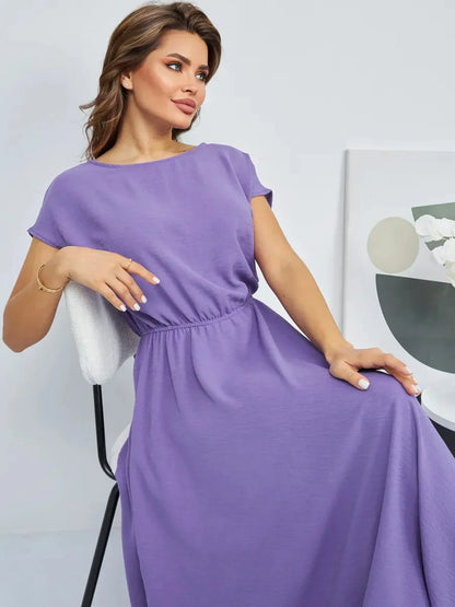 Model wearing Lavender Breeze Maxi Dress in light lavender, showcasing its flowing silhouette and soft gathered waist.