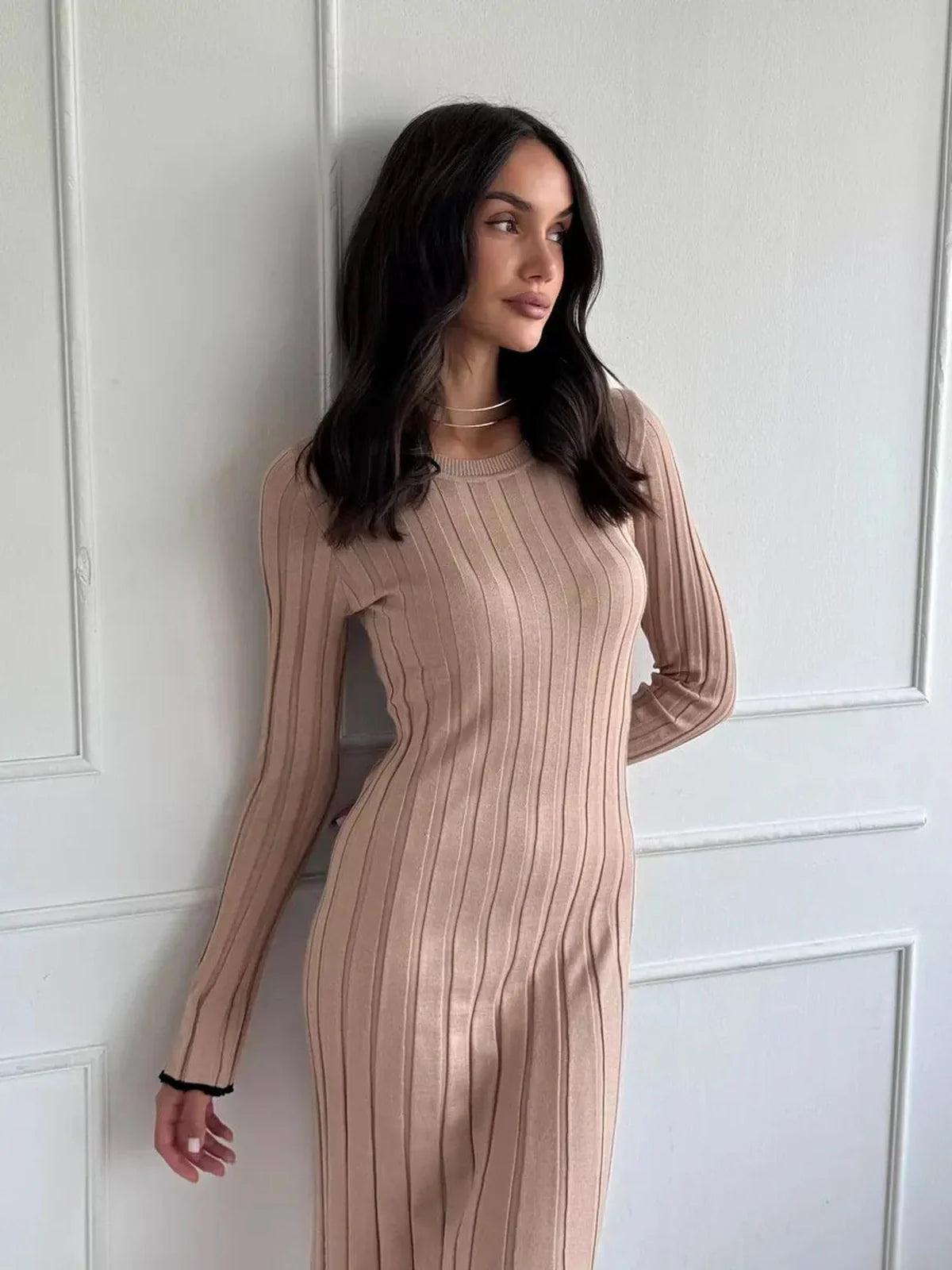Model wearing the Sahara Curve Maxi Dress in sandstone beige, showcasing its ribbed texture and elegant fit.