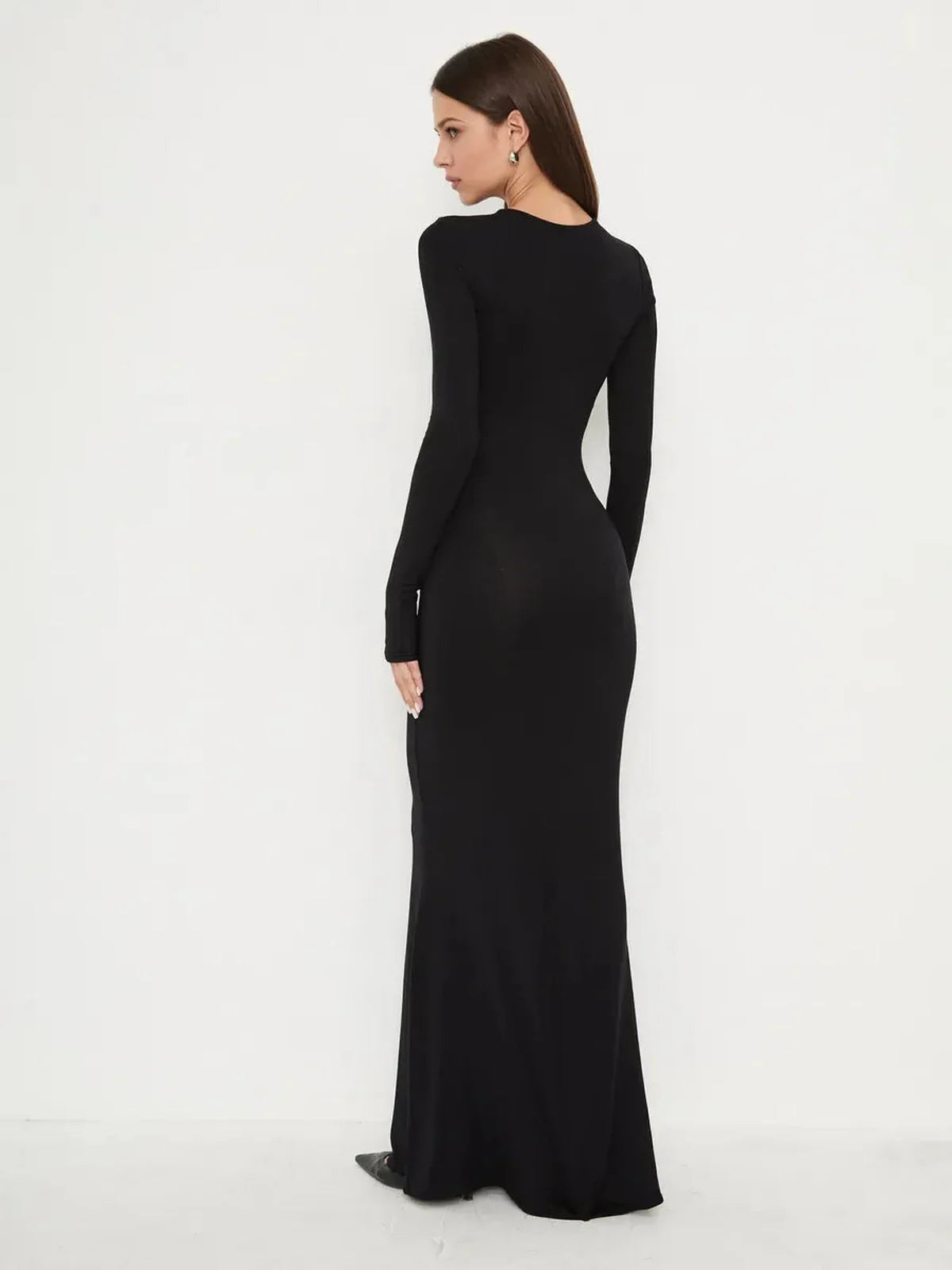 Elegant full-length black dress, Sculpted Noir, showcasing a smooth silhouette and mermaid hem in a minimalist design.