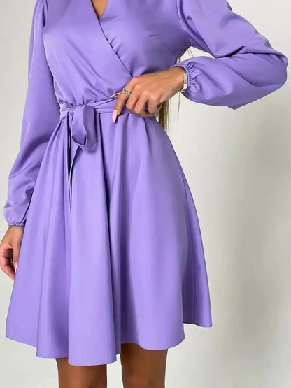 Elegant lavender mini dress with V-neckline and cinched waist, perfect for feminine, sophisticated style.