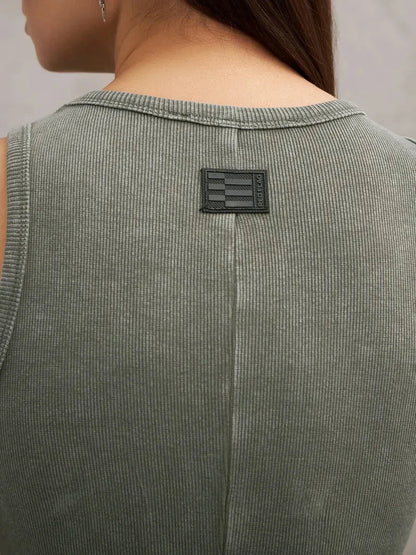 Close-up of the back of the Verdant Curve Maxi Dress in washed khaki showcasing its rib knit texture and logo detail.