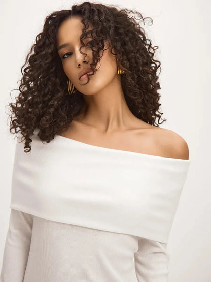 Model wearing the Sculpted Grace Maxi Dress featuring an off-shoulder neckline and soft, flowing fabric.