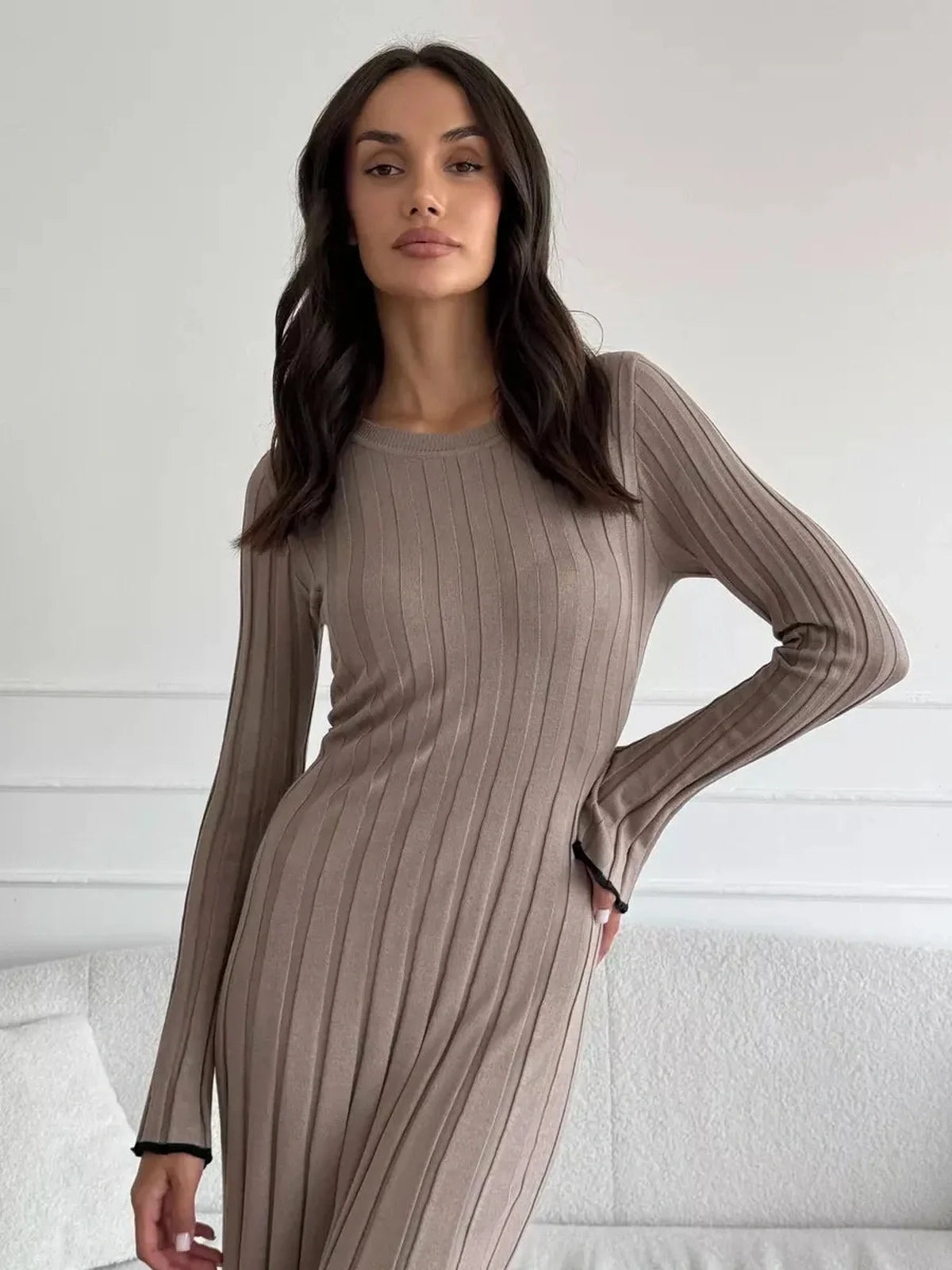 Model wearing a Contour Maxi Dress in ribbed knit, showcasing a chic full-length silhouette and elegant vertical lines.
