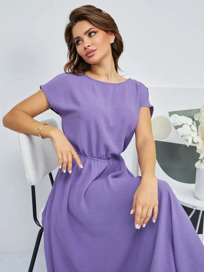 Model wearing a Lavender Breeze Maxi Dress, showcasing its lightweight fabric and flowing silhouette in a soft lavender hue.