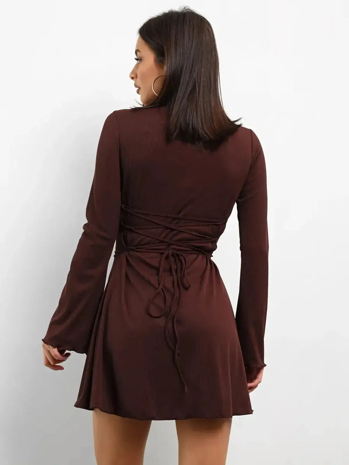 Cocoa Laced mini dress with adjustable lace-up back and flared long sleeves, perfect for cocktail or wedding guest attire.