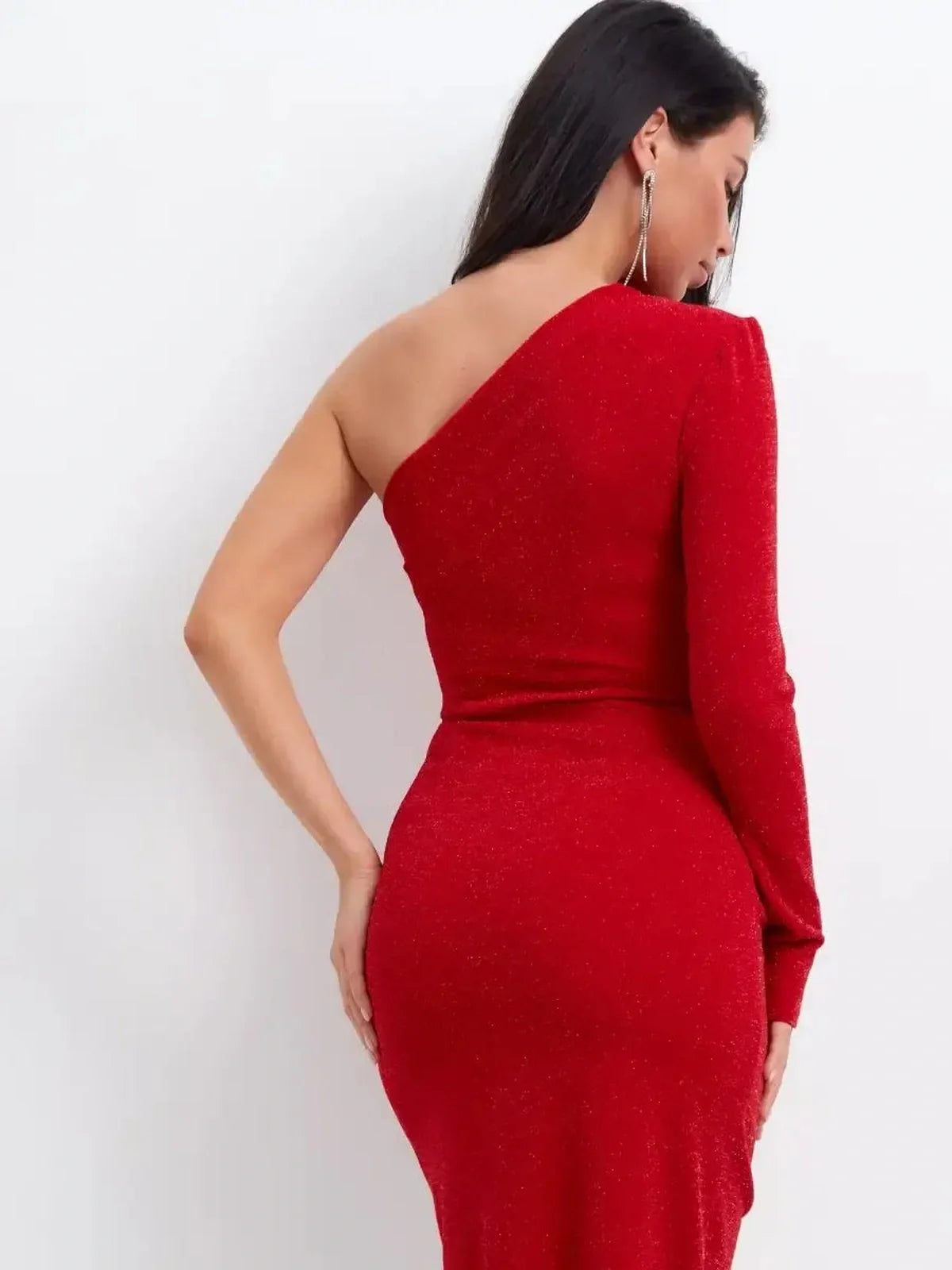 Back view of a red glitter one-shoulder maxi dress with a gathered waist and a vibrant silhouette.