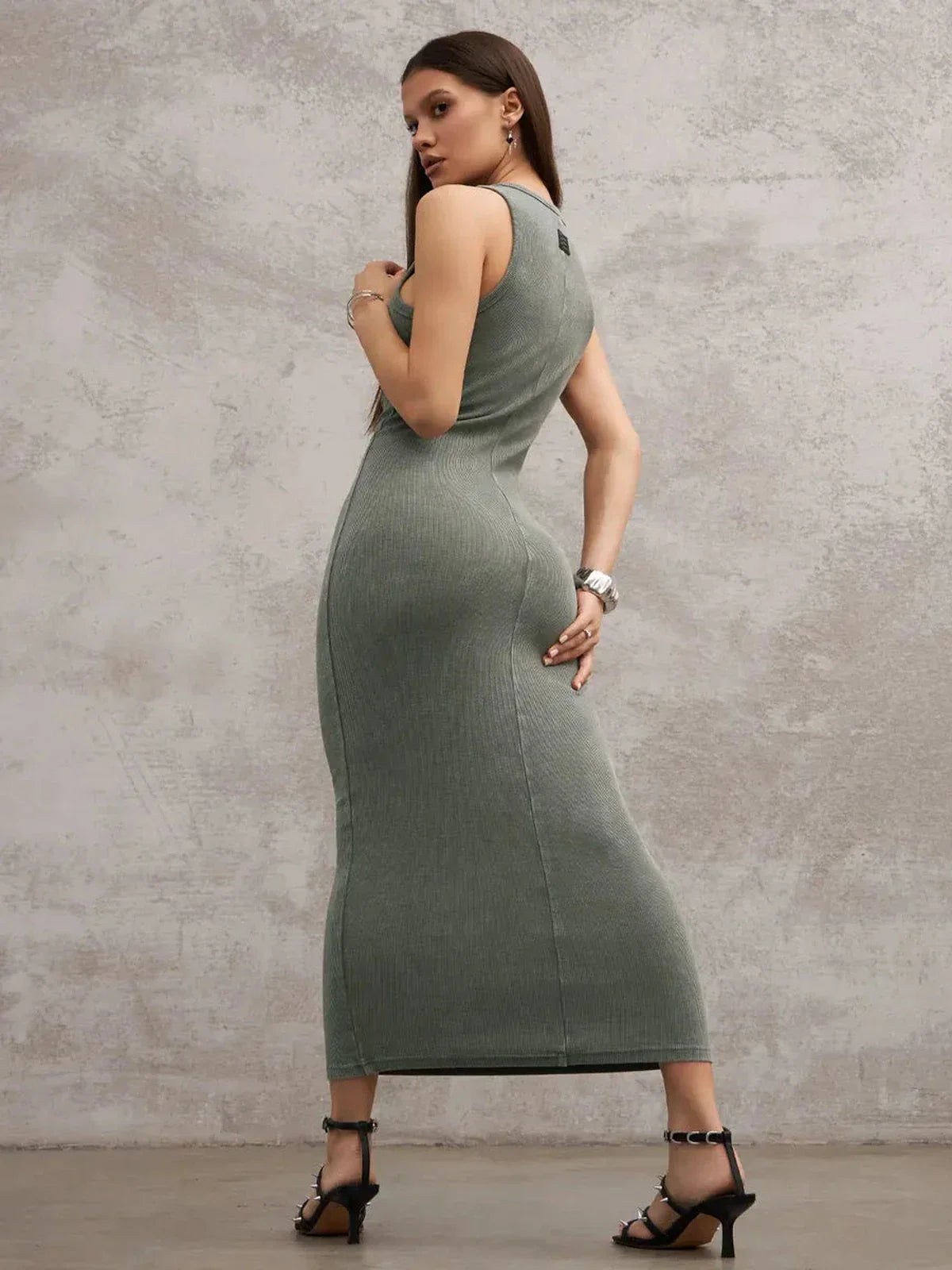 Model showcasing the Verdant Curve Maxi Dress in washed khaki, featuring a sleeveless design and sculptural fit.