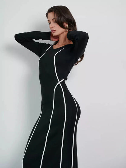 Model wearing Midnight Curve Maxi Dress with elegant white piping, showcasing its sculpting silhouette and sleek design.