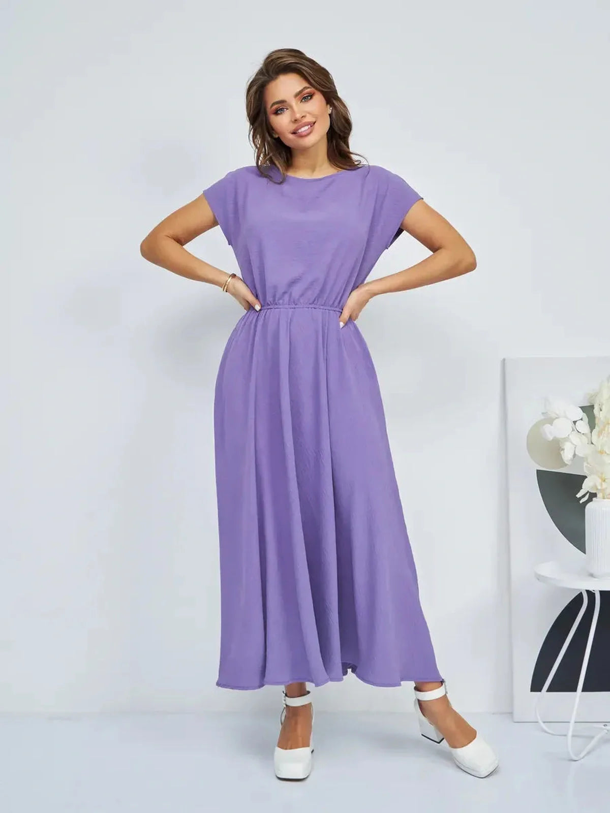 Model wearing a lightweight lavender maxi dress with a gathered waist, perfect for summer outings.