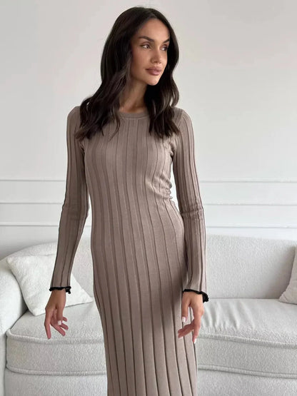 Model showcasing the Contour Maxi Dress in ribbed knit, highlighting its elegant fit and ruffle hem.