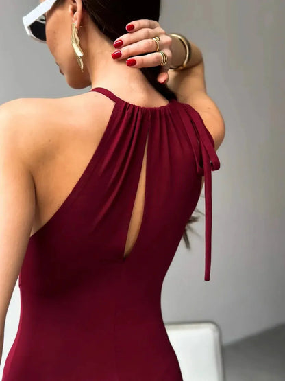 Back view of Maxi Dress Élan features a draped halter design and keyhole detail in rich burgundy, showcasing elegant styling.